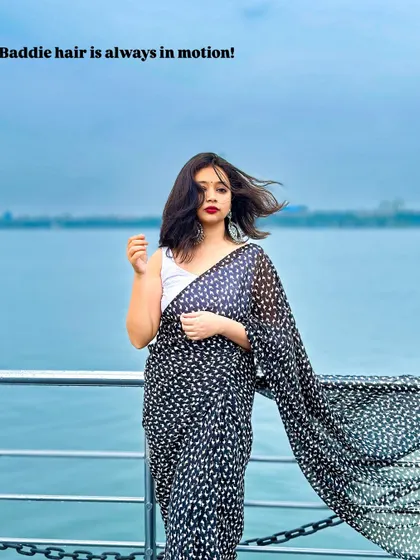 Baddie hair is always in motion! This look is for my girls who want to channel that main character energy. A simple printed black georgette saree with a white tank top is effortlessly cool and chic.