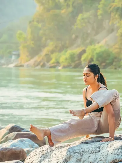 Finding a moment of focus and flexibility with this seated twisting pose on the rocks by the Ganga in Rishikesh.