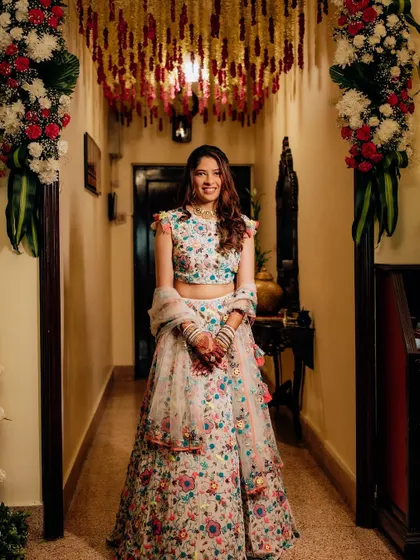 A full-length view of the Mehendi look, showing how the soft, pretty makeup works perfectly with the colorful and festive lehenga.