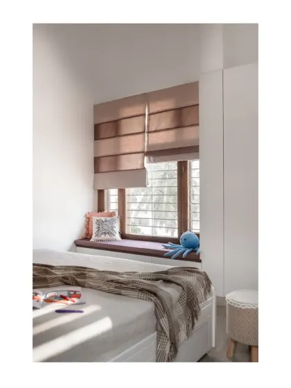 A cozy bay window seat in the children's room provides the perfect nook for reading and relaxing, bathed in natural light.