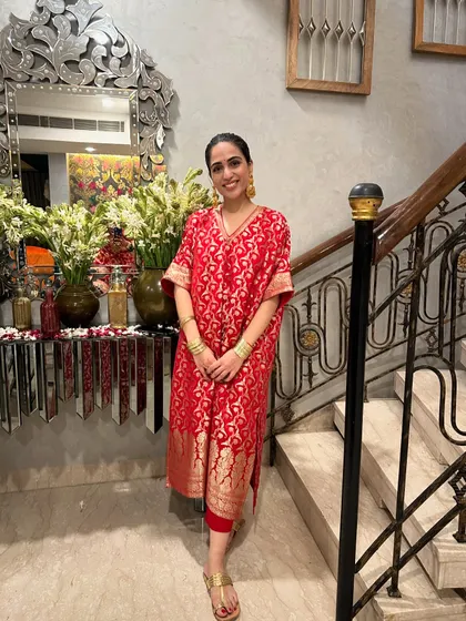 Another self-designed red kaftan, this one made from a Banarasi saree. It’s a great way to repurpose old sarees into something new and stylish.