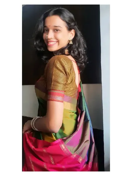 Wearing a traditional multi-colored silk saree for a festive performance. This look is well-suited for cultural events, religious ceremonies, or traditional family functions where a classic aesthetic is desired.