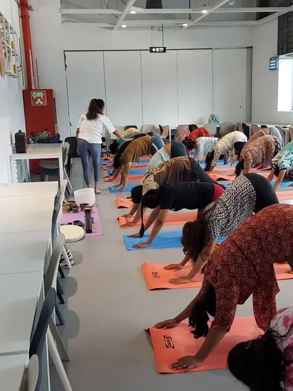 Guiding the IKEA team through Downward-Facing Dog. I walk around the room to offer verbal cues and ensure everyone is practicing safely.