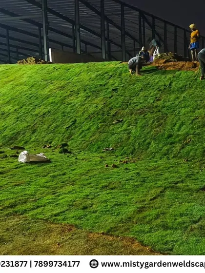 Our team meticulously laying natural turf on a sloped area, ensuring complete coverage and a healthy start for this large-scale farmhouse lawn.