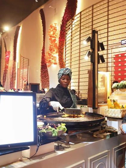 Our team includes chefs from around the world, here seen preparing African-inspired grilled dishes. We pride ourselves on offering a truly global menu, tailored to your event's theme.