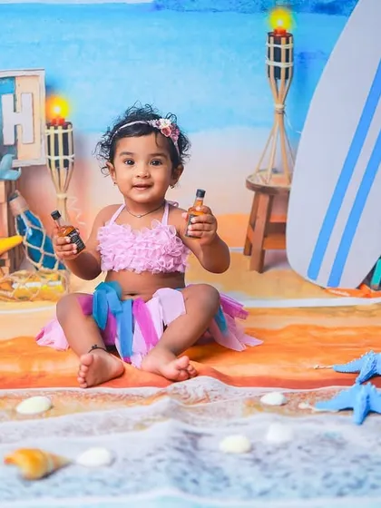 Let's go to the beach. This vibrant, sunny setup is perfect for celebrating your little one's bright personality. I provide all the props to create a fun, beachy vibe right in my studio.