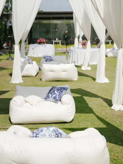 Comfortable and chic white beanbag seating arranged on the lawn for a relaxed and stylish Mehendi celebration.