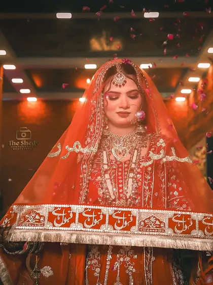 A beautiful shot of the bride during her entrance, with rose petals showering down. This photo captures the emotion and beauty of the moment.