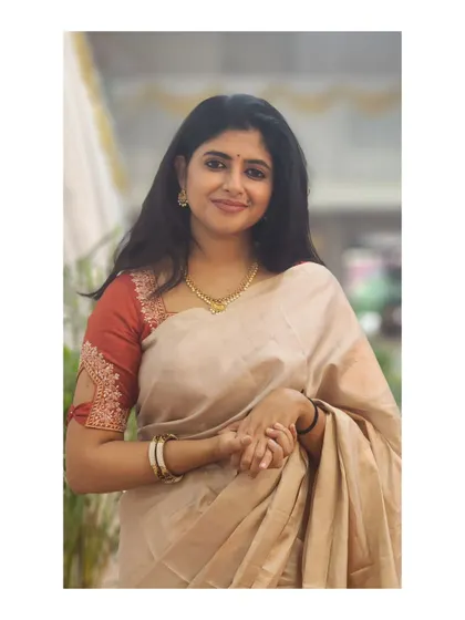 A graceful pose in a lovely beige silk saree.