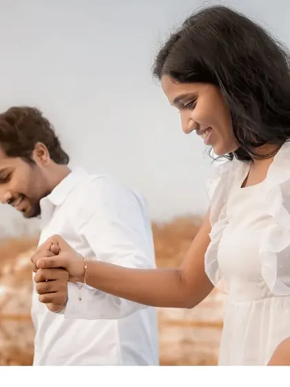 A close-up of the couple holding hands and sharing a laugh. This candid shot perfectly captures the joy and excitement in the lead-up to their wedding.