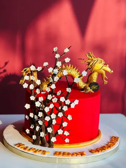 An intricate dragon-themed cake for a special birthday. The golden dragon and delicate cherry blossoms are all handcrafted, showing the artistic detail I put into my custom orders.