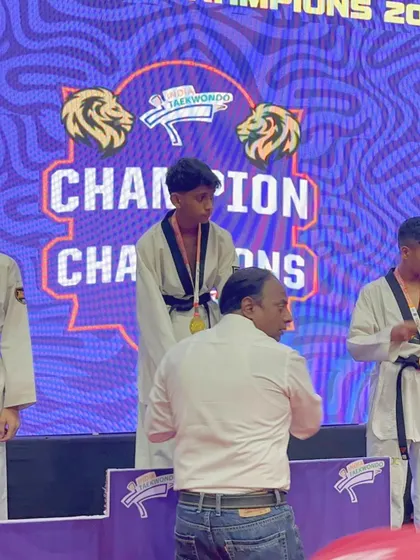 A young champion on the podium. Here, our athlete receives his gold medal at the 'Champion of Champions' final, a moment that reflects countless hours of practice and dedication.