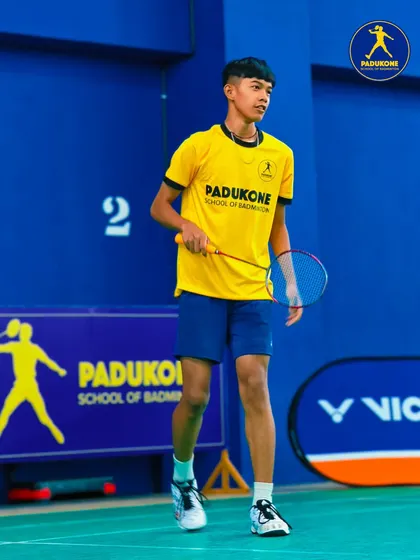 Every champion starts somewhere. A young player on court, focused and ready, embodying the dedication our training programs inspire.