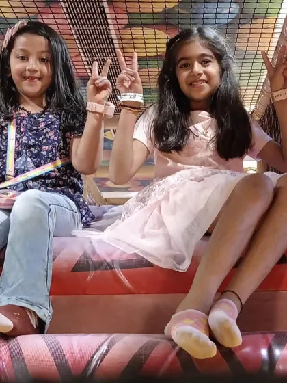 Peace, love, and playtime! Two friends take a moment to pose for a picture inside our multi-level play structure.
