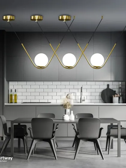 A beautiful linear pendant with three globe lights nestled in a wavy gold frame. This is a perfect light for over a kitchen island or a long dining table.