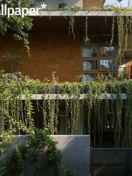 The 'House of Greens' facade featured in Wallpaper*, highlighting the cascading greenery that has become a signature of the project.