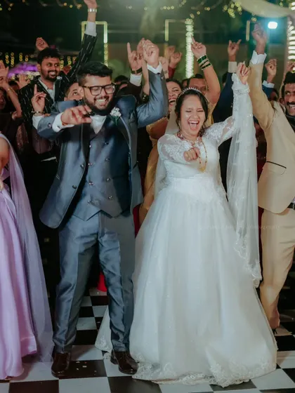 The couple and their friends celebrate on the dance floor, a perfect picture of joy and friendship.