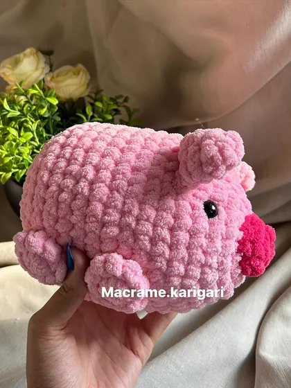 This little pink pig is made from the softest chunky yarn, making it extra squishy and fun to hold. Its curly tail and sweet snout are details we love to craft.