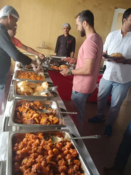 Guests enjoying the hot and fresh food from our buffet at a clubhouse party.