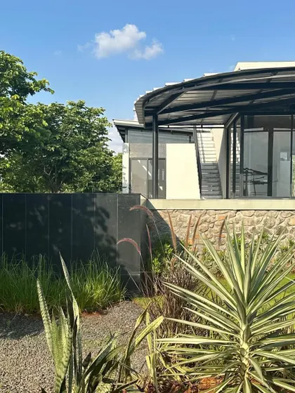 The western facade of Pavilion House under construction, showing the steel structure and curved roofline before the final finishes were applied.