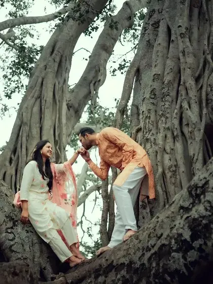 A chivalrous kiss on the hand, framed by the magnificent roots of an ancient banyan tree. A truly timeless pre-wedding shot.