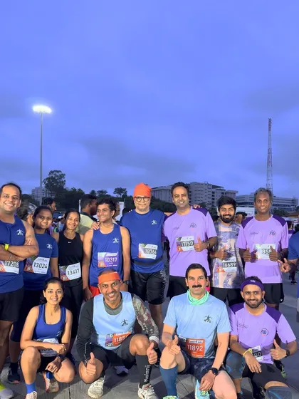 Our runners in their blue and purple club kits, posing for group photos before and after a major 10k event.