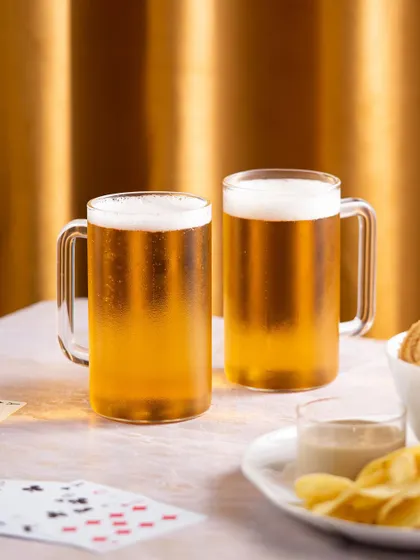 A festive shot of beer mugs against a golden background, perfect for holiday-themed marketing campaigns.