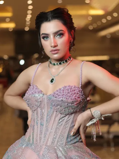 A close-up of the bodice of the metallic gown, showing the pearl and crystal embellishments on the bustier.