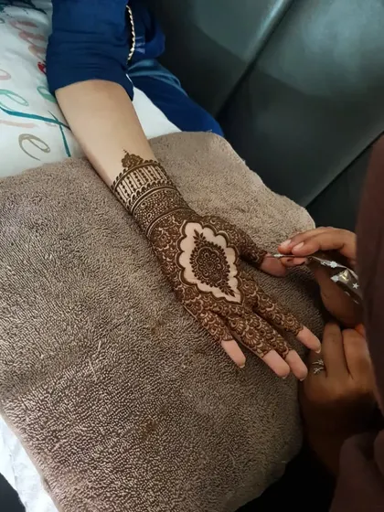A behind-the-scenes shot of me working on an intricate Pakistani-style henna design.