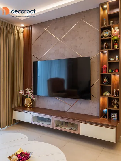 A perfect example of integrated design, this TV unit features a textured back panel with rose gold inlays and a tall, illuminated display shelf. The floating console provides storage without feeling heavy.