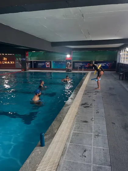 An overview of an aqua yoga class in an indoor pool. This practice is perfect for all weather and provides a safe environment for exploring movement.
