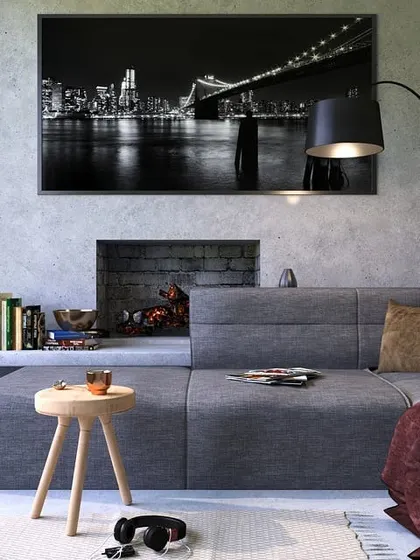 This modern living room features a light grey concrete-style paint finish. This gives the space an industrial yet sophisticated look, proving that neutral colors can be impactful.