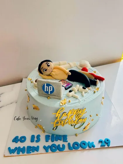 A cake that says "40 is fine when you look 29," featuring the birthday boy's favorite things.