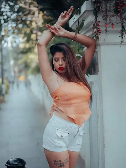 A full-body shot of a model in a casual outfit. The urban street setting and her relaxed pose make this a great example of everyday street style.