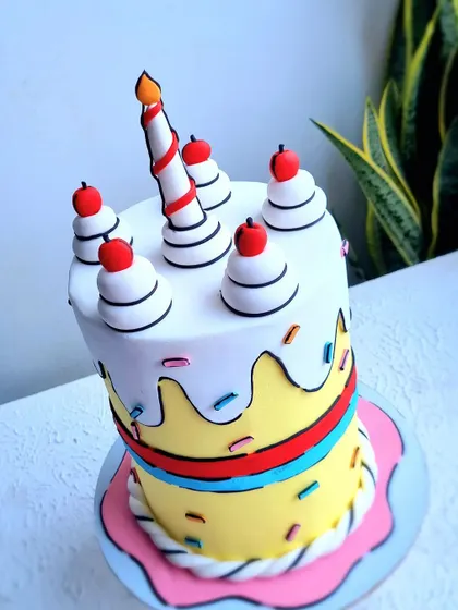 This comic book style cake is a fun and trendy design. I teach the technique of using black fondant outlines to create this 2D cartoon effect, making the cake look like it jumped right out of a drawing.