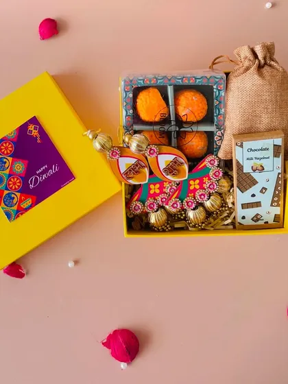 The open yellow box and lid, showing the custom Diwali sticker we can add to our packaging.