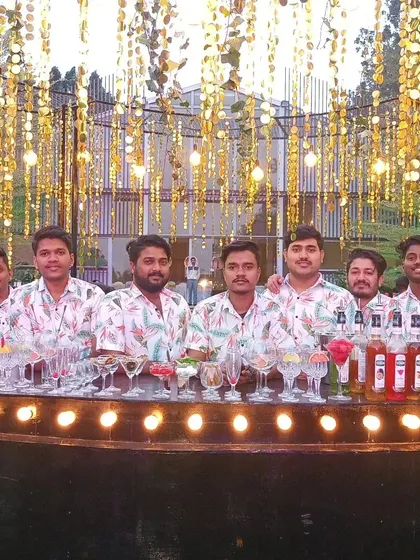 The team poses for a photo at a glamorous event with stunning gold decor. We are proud to be part of such beautiful celebrations.