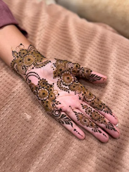 A delicate and modern take on Arabic henna, with spaced-out floral motifs on the palm.