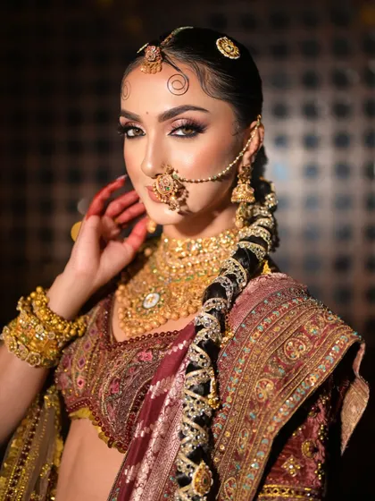 A side profile showcasing the intricately decorated traditional braid, a true work of art that completes this royal bridal look.