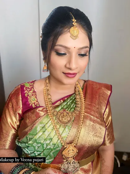 A portrait of Manjula, looking serene and beautiful. The traditional jewelry and soft makeup enhance her natural pregnancy glow.