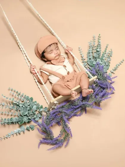 This little guy is dreaming away on a swing decorated with lavender. The soft colors and floral accents create such a calming scene.