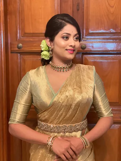 The final look for this client. The golden saree, messy bun, and glowing makeup create a look that is both traditional and modern.