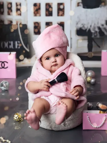 A serious but adorable look from our little model in the spa-themed setup, surrounded by luxury-brand props.