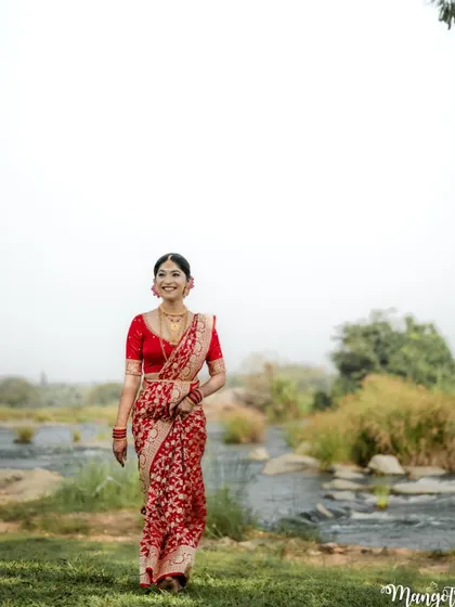 A walking shot of the bride, her saree flowing beautifully. Her makeup is designed to look great in motion and in still photos.