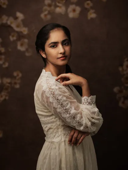 "You don't make art...you find it." This portrait, with a floral background, feels like a found moment of beauty, captured forever.