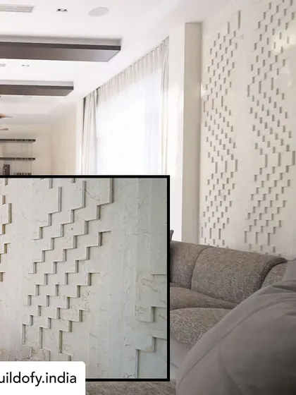 This is a limestone panel in the bar area with a meticulously crafted texture. The geometric, stepped pattern creates a beautiful play of light and shadow, turning a simple wall into a sophisticated architectural feature.