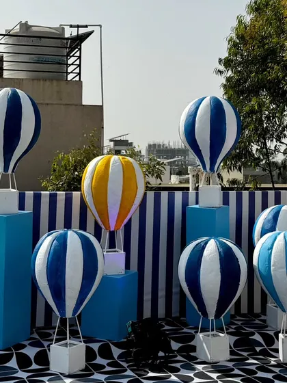 From concept to execution in just 42 hours. This St. Tropez inspired decor in Ahmedabad involved transforming a bungalow with custom-painted walls, fruit-based installations, and unique props, all on a tight deadline.