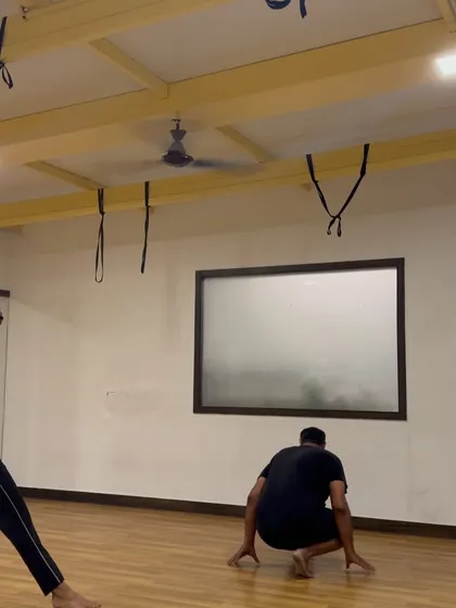 A student demonstrates the transition from a cartwheel to a handstand, a drill that builds control and fluidity. This shows how we link different movements together to create seamless sequences.