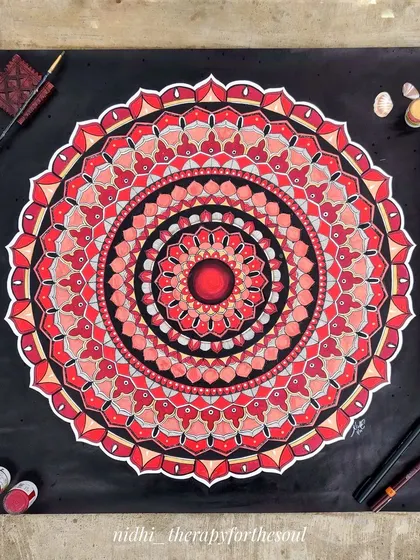 A custom 60x60cm mandala in a powerful red, black, and white color combination. The bold colors and sharp contrasts make for a dramatic and eye-catching piece of wall art.
