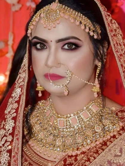 A close up portrait showcasing the balance between bold eyes and a defined lip. The pink toned jewelry is perfectly matched with the makeup, tying the whole look together.